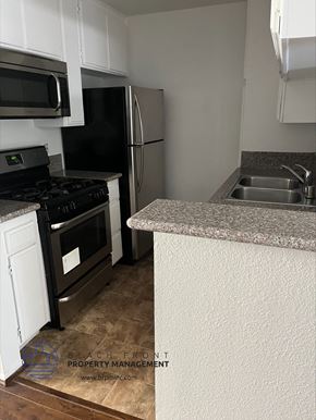 Los Angeles apartment for rent - A kitchen with a stove, refrigerator, and sink.